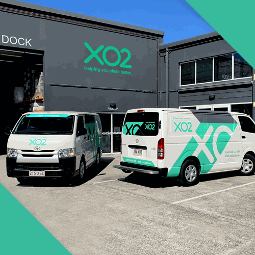 Two XO2 delivery vans outside the loading dock at the XO2 head office
